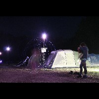 Person swinging lights in the night at OHM2013